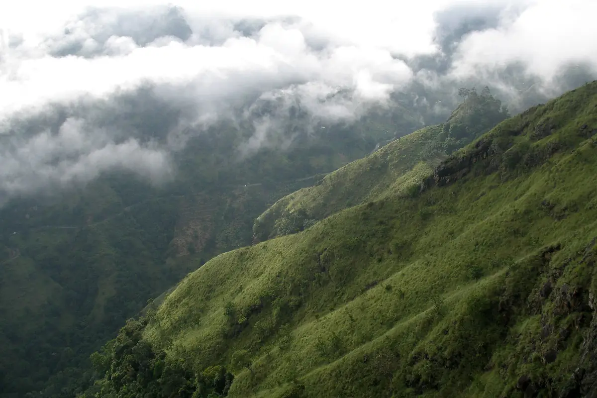Steep green slopes of the Ella valley under low cloud